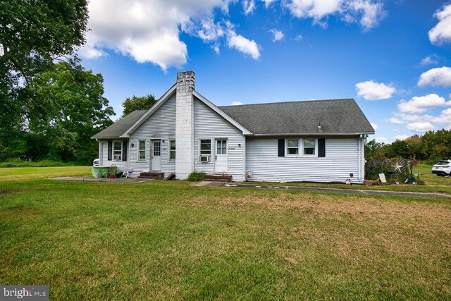 back of house with a lawn