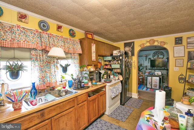 kitchen with ornamental molding and light tile patterned floors