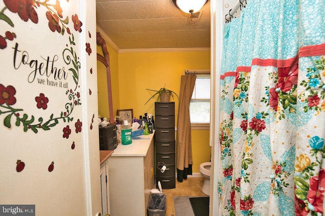 bathroom featuring vanity, crown molding, and toilet