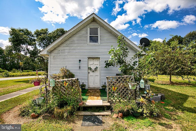 bungalow-style home featuring a front yard