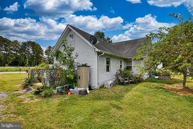 view of side of property with a lawn