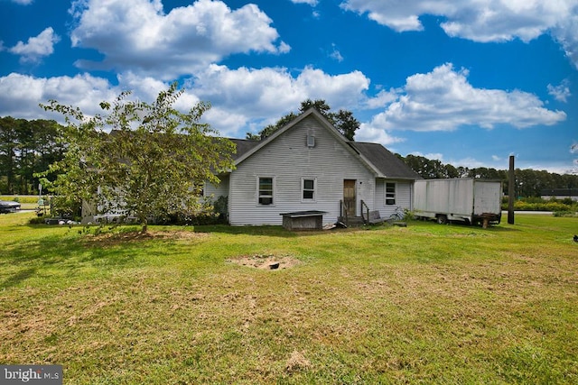 view of side of home featuring a yard