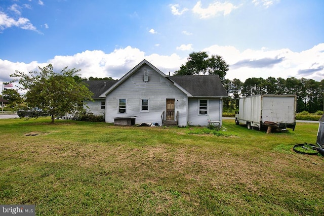 rear view of house with a yard