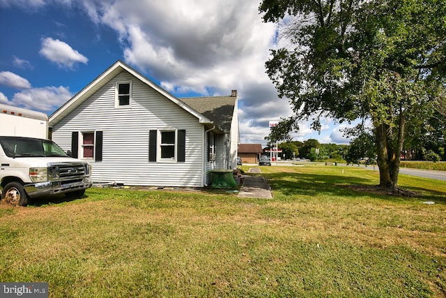 view of home's exterior with a yard