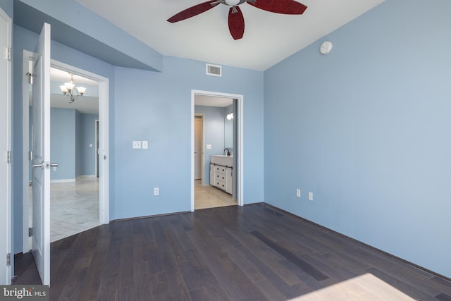 unfurnished bedroom featuring sink, tile patterned flooring, ensuite bathroom, and ceiling fan with notable chandelier