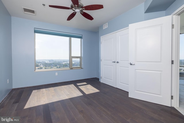 unfurnished bedroom featuring hardwood / wood-style flooring, a closet, and ceiling fan