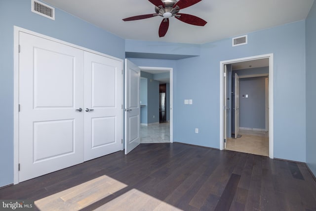 unfurnished bedroom with tile patterned floors, a closet, and ceiling fan