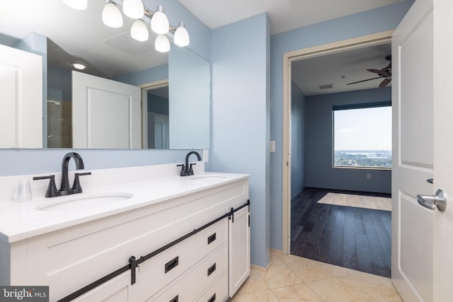 bathroom with ceiling fan, wood-type flooring, and vanity