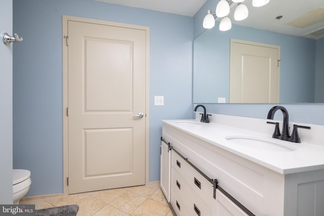 full bathroom with a sink, toilet, and double vanity