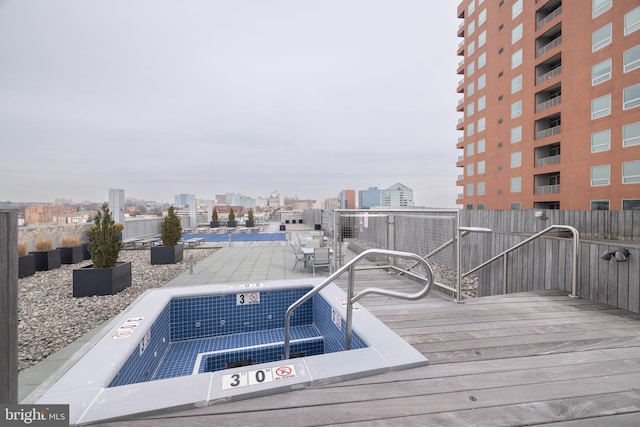 wooden deck with a jacuzzi