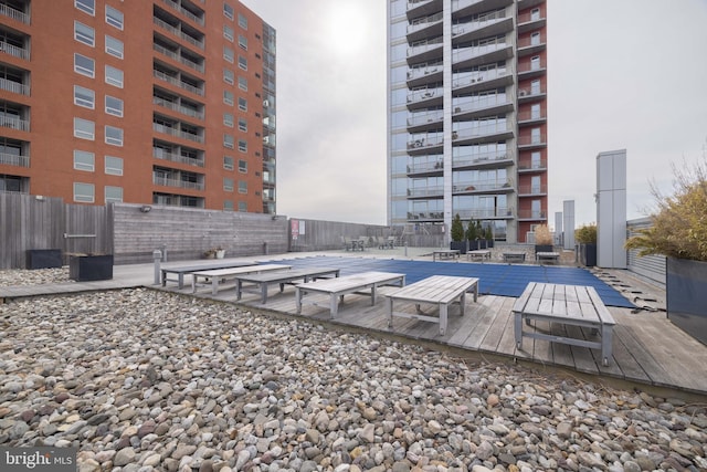 view of swimming pool featuring fence and a patio