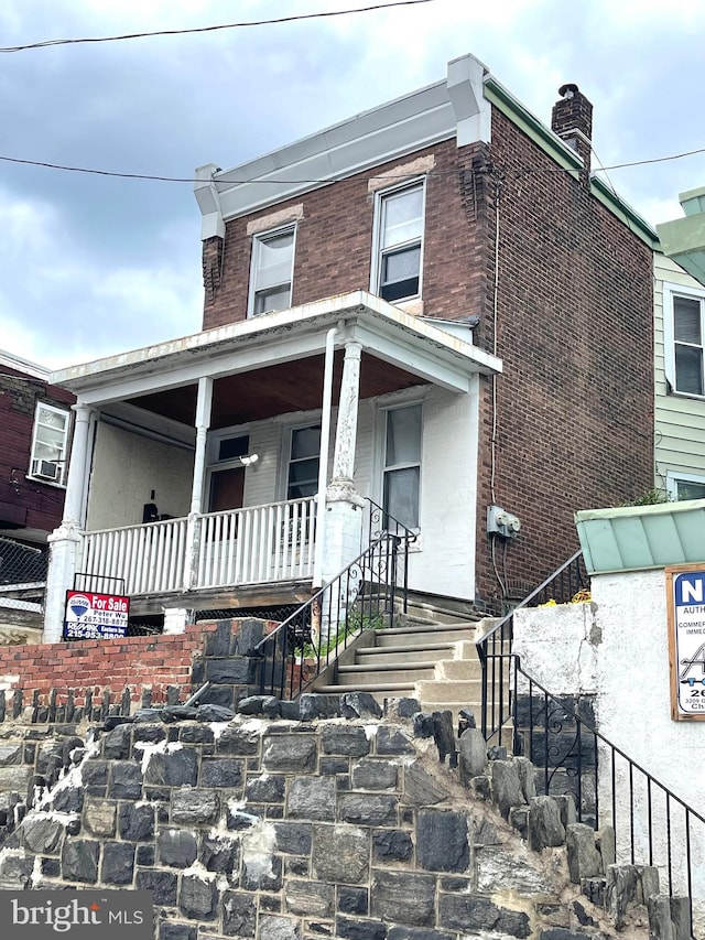 view of front facade featuring cooling unit and covered porch