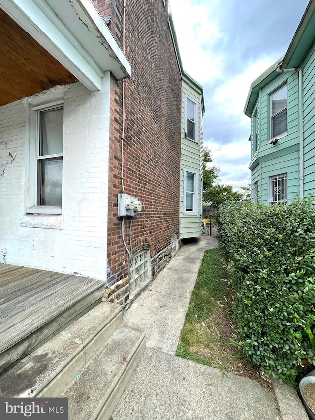 view of property exterior featuring a wooden deck