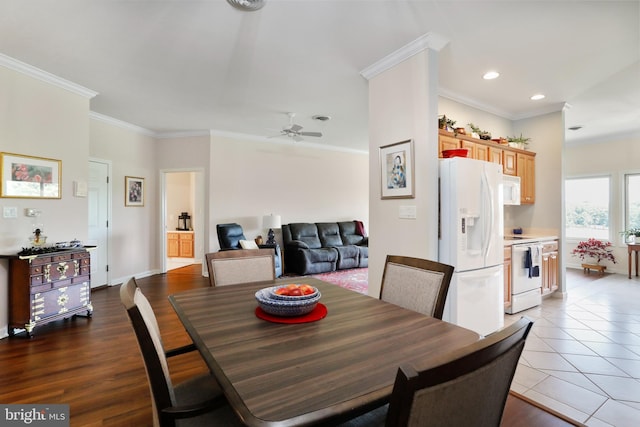 dining room with light hardwood / wood-style flooring, ceiling fan, and ornamental molding