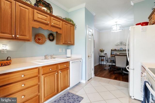 kitchen with ornamental molding, light wood-type flooring, white appliances, and sink