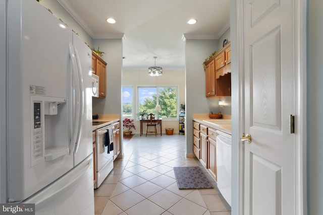 kitchen featuring crown molding, hanging light fixtures, light tile patterned floors, and white appliances