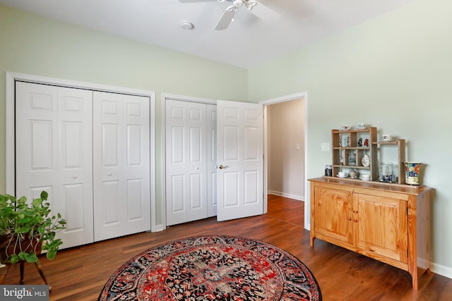 interior space with ceiling fan and dark hardwood / wood-style flooring