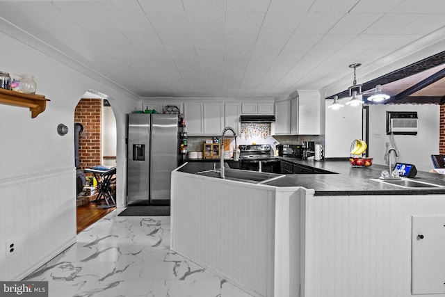 kitchen with light wood-type flooring, white cabinets, kitchen peninsula, decorative light fixtures, and stainless steel fridge with ice dispenser