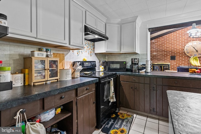 kitchen with dark brown cabinetry, light tile patterned floors, brick wall, black appliances, and white cabinets