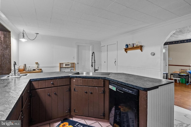 kitchen featuring sink, light tile patterned flooring, dark brown cabinetry, and dishwasher