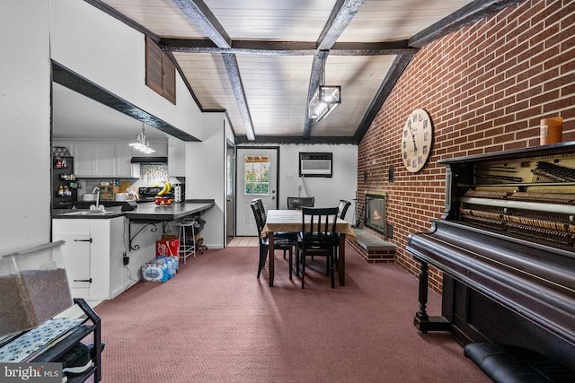 interior space featuring lofted ceiling with beams, wooden ceiling, brick wall, and carpet floors