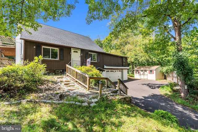 view of front of home with an outdoor structure and a garage