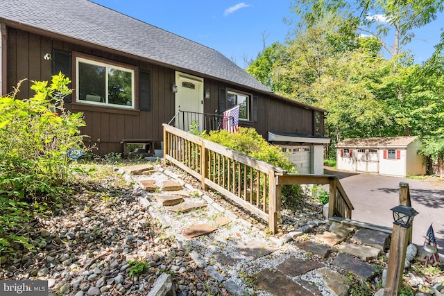 view of front of house featuring a storage unit