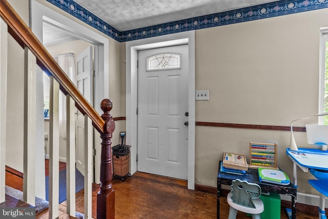 foyer with dark hardwood / wood-style floors