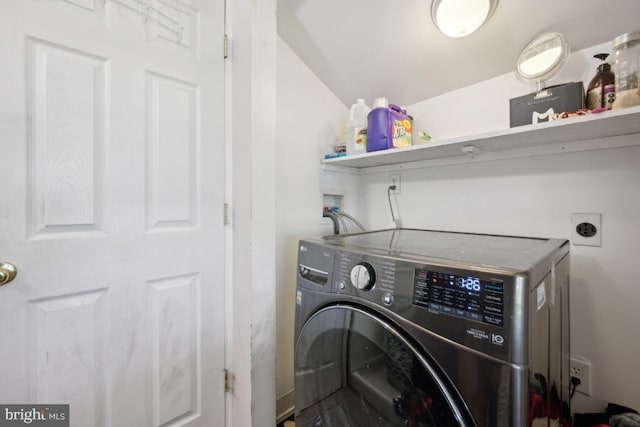 laundry room featuring laundry area and washer / dryer