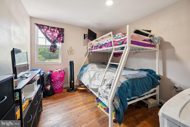 bedroom featuring baseboards and wood finished floors