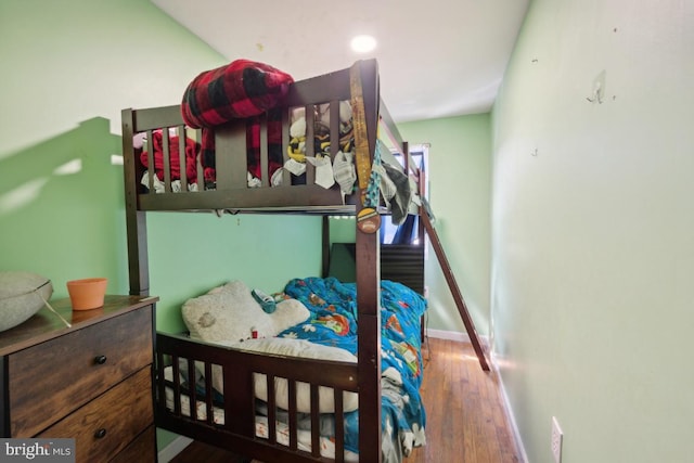 bedroom featuring baseboards and wood finished floors