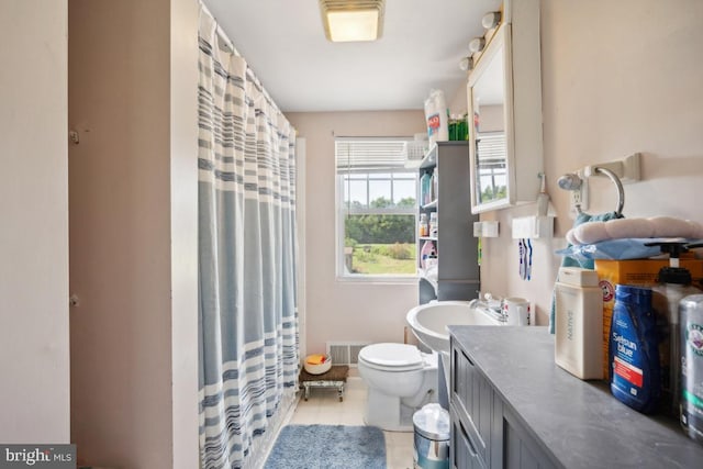 bathroom featuring toilet, tile patterned flooring, visible vents, and vanity