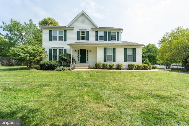 colonial inspired home with a front lawn