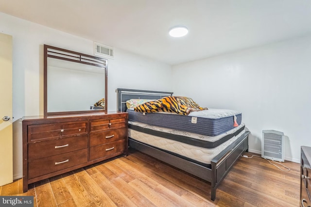 bedroom with hardwood / wood-style flooring