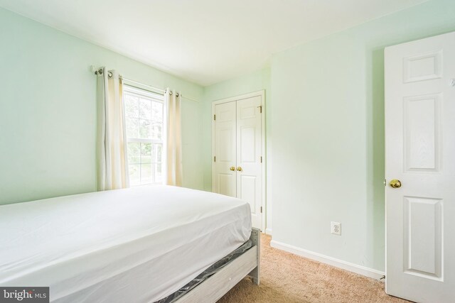 carpeted bedroom with a closet