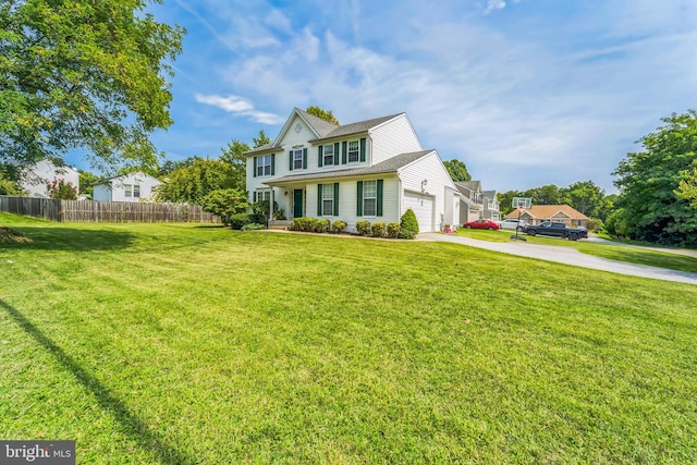 view of front of property with a garage and a front lawn