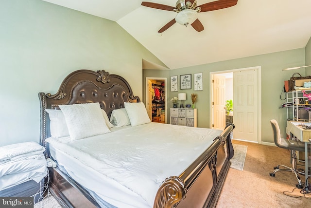 carpeted bedroom with lofted ceiling, a walk in closet, ceiling fan, and a closet