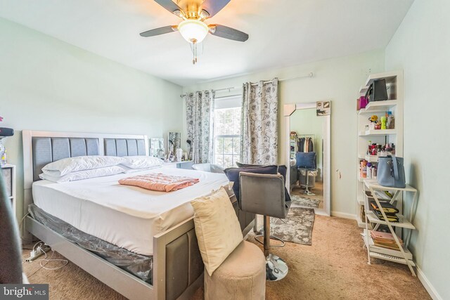 bedroom featuring ceiling fan and light colored carpet