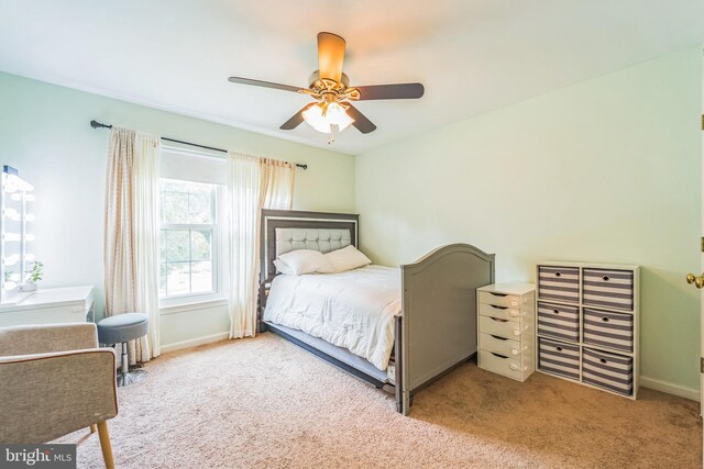 bedroom with ceiling fan and light carpet