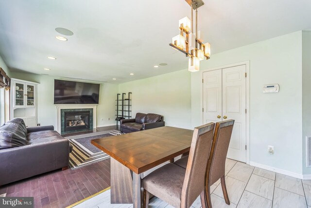 dining space with a notable chandelier and light wood-type flooring