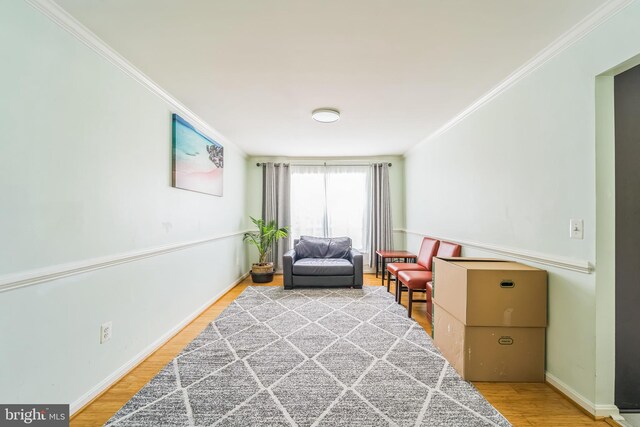 sitting room featuring crown molding and wood-type flooring