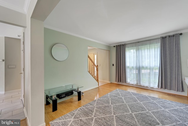 interior space featuring ornamental molding and light hardwood / wood-style flooring