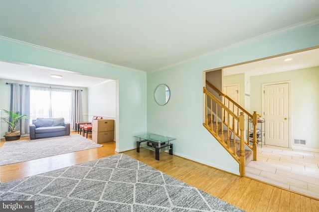 interior space featuring light wood-type flooring and ornamental molding