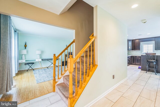 stairs with hardwood / wood-style flooring