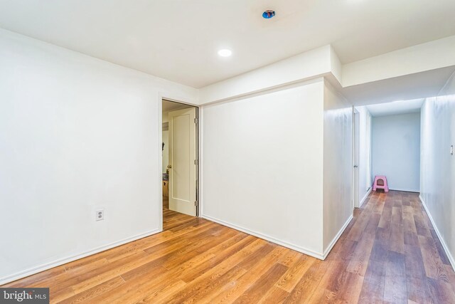 empty room with hardwood / wood-style flooring