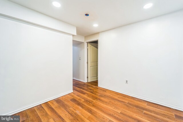 spare room featuring wood-type flooring