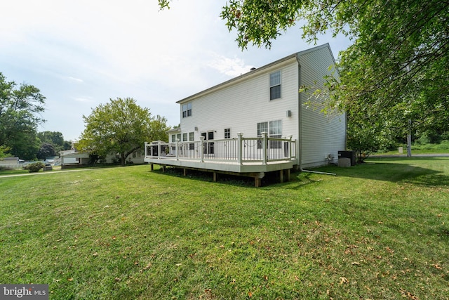 back of house featuring a yard, a deck, and cooling unit