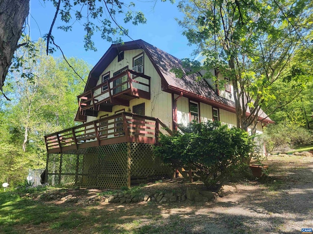 view of side of home with a wooden deck