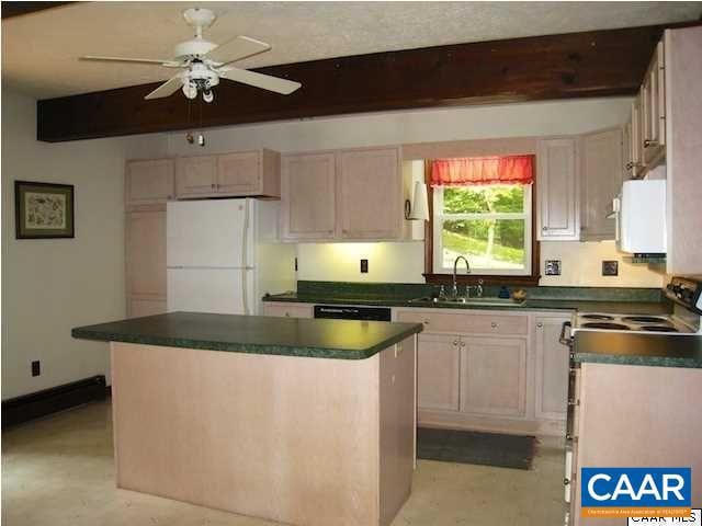 kitchen with a kitchen island, white appliances, ceiling fan, and sink