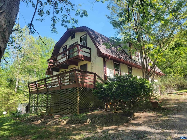 view of home's exterior featuring a wooden deck